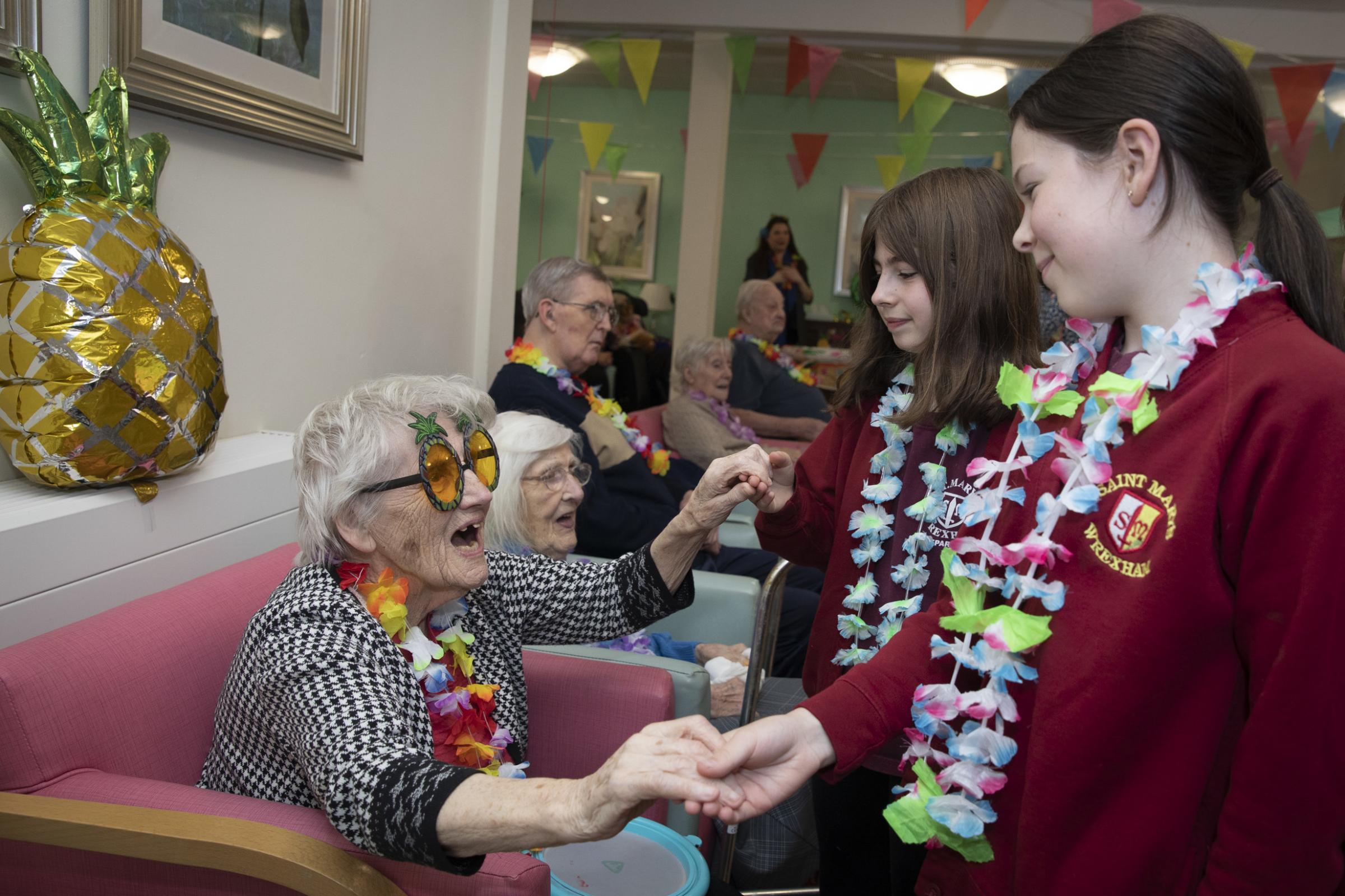 Resident Irene Jarvis with St Marys pupils Alexandra and Ivy. Photo: Mandy Jones