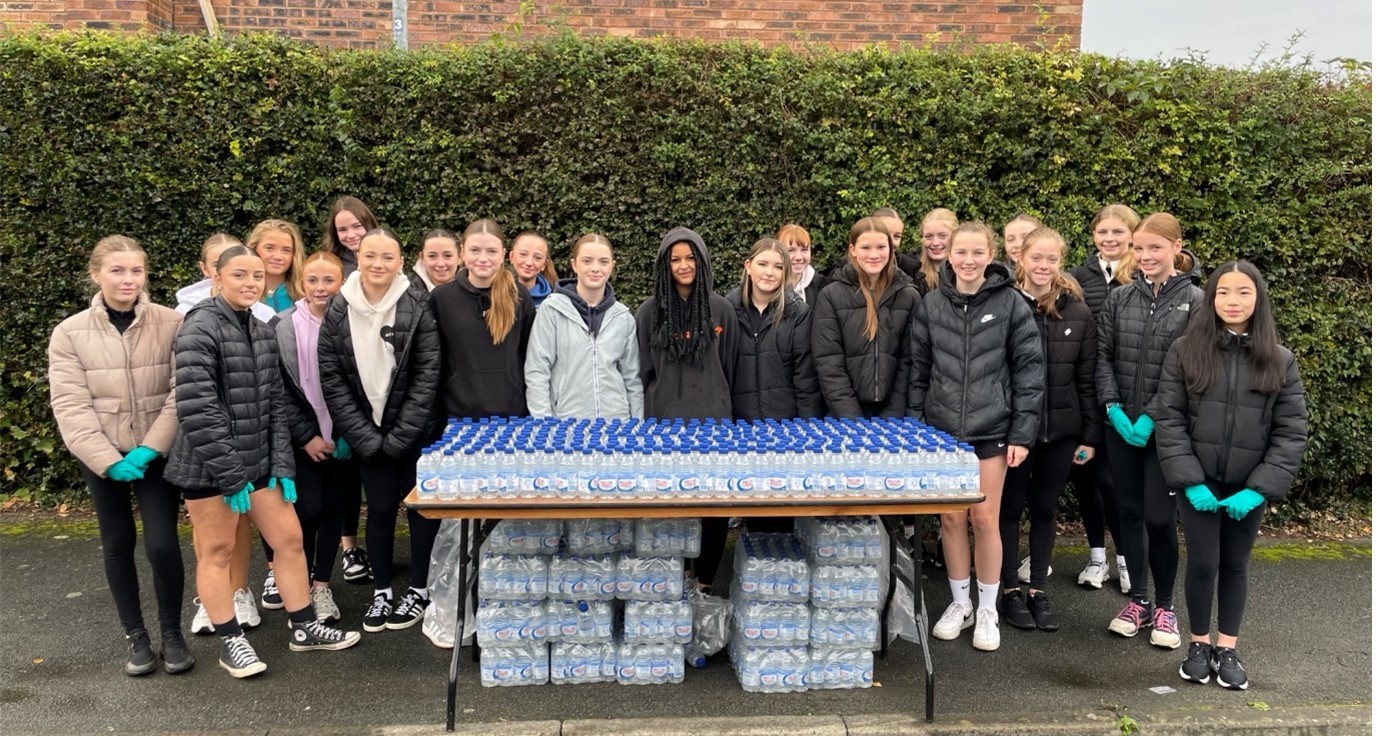 Students from Darland High School run a water station during the Chester Marathon.