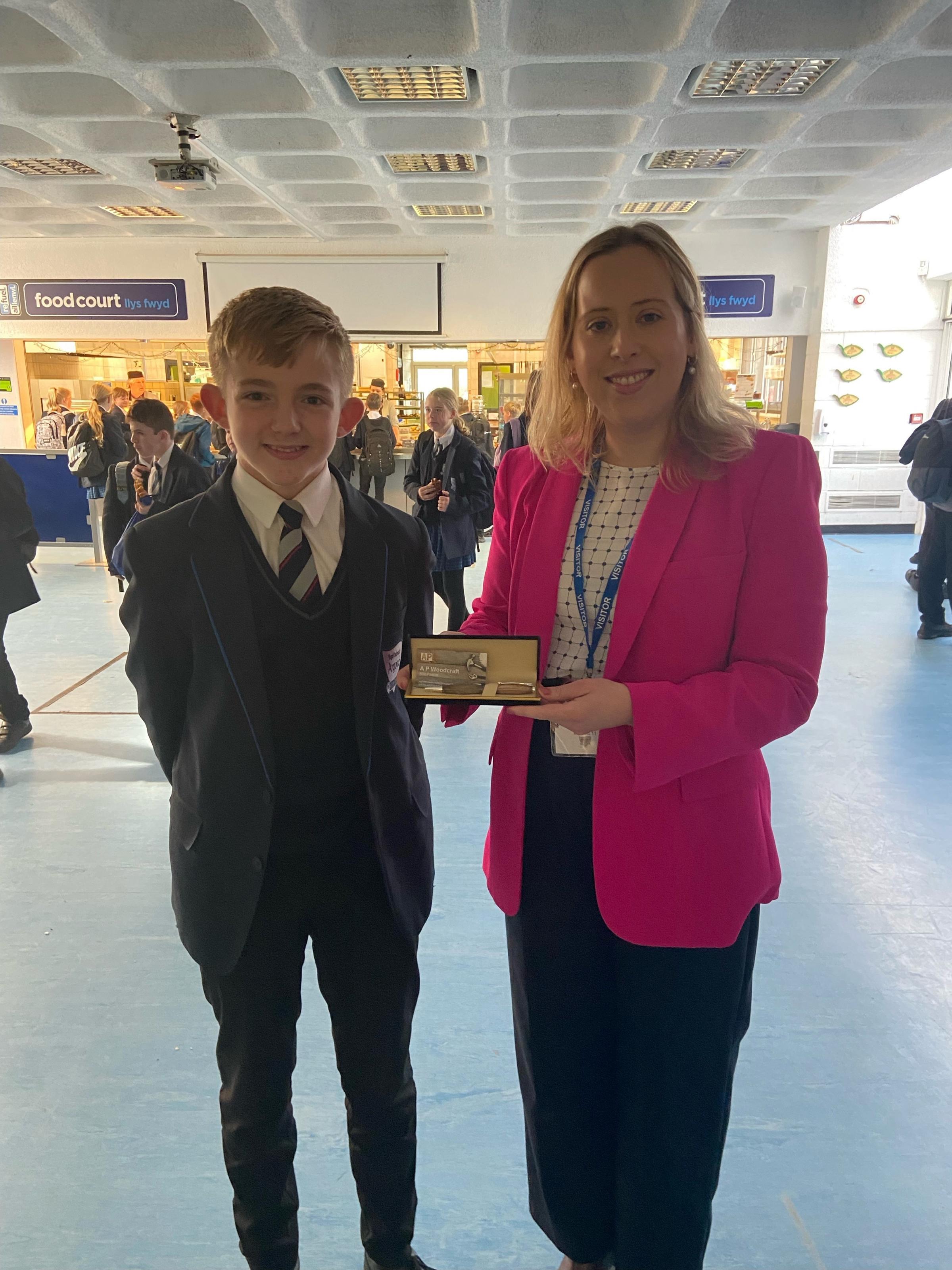 Alfie Pearce, Year 9, presents Becky with a handmade wooden engraved pen to thank her for taking the time to visit Argoed High School.