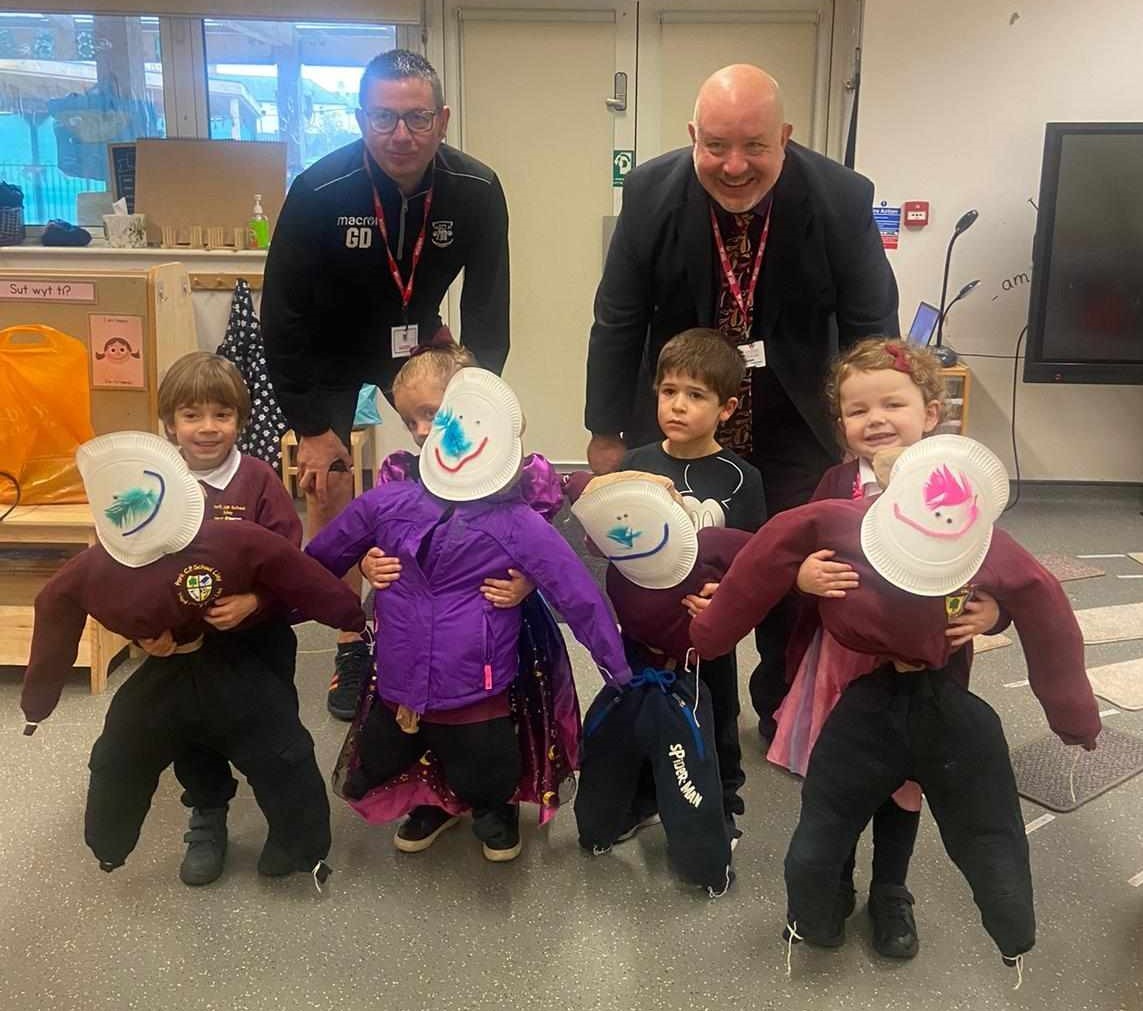 Gavin Davies, from Llay Welfare FC and Cllr Rob Walsh, collect four Guys from pupils at Llay Park CP School.