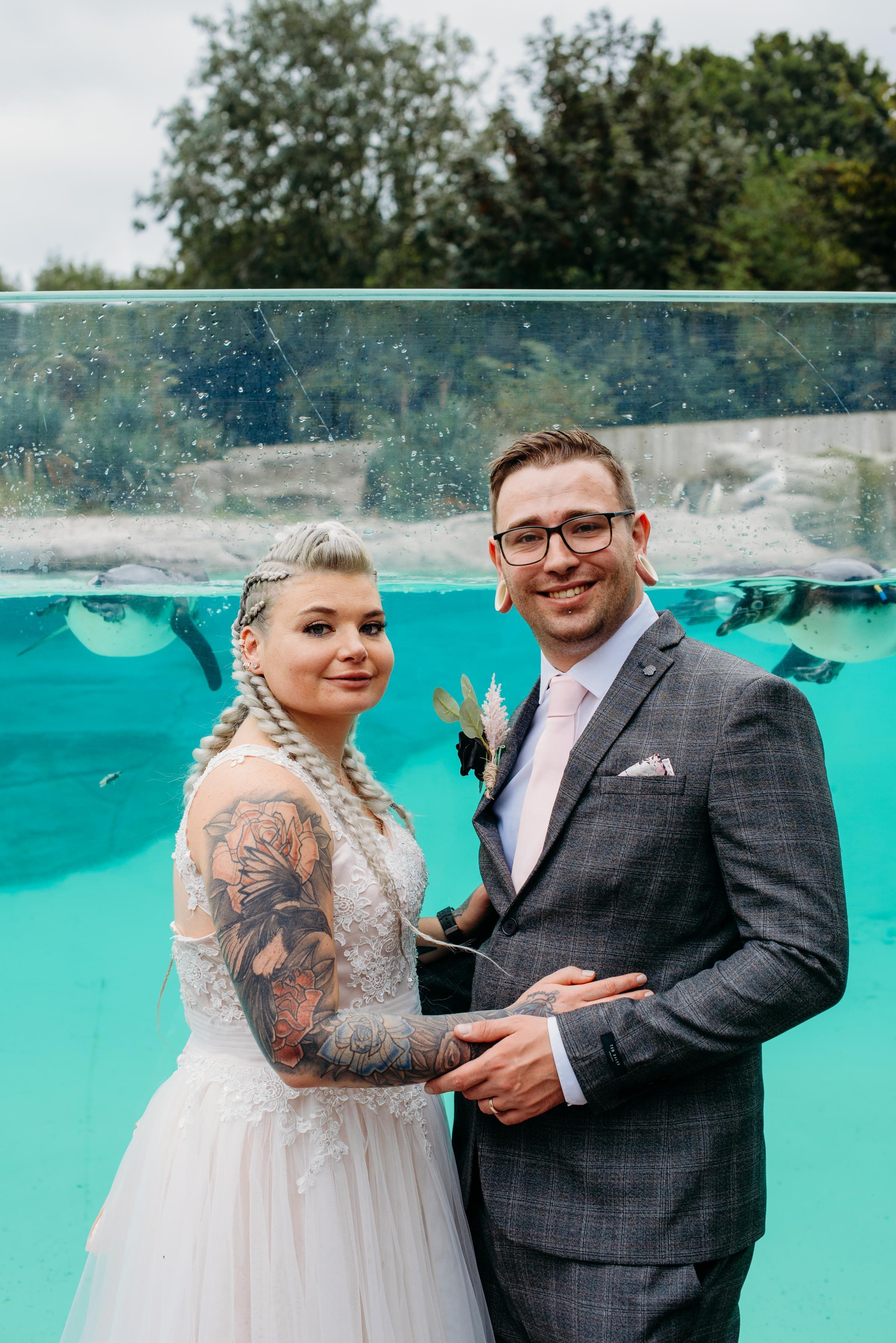 Jessica and Jon Solari celebrating with the penguins at Chester Zoo.