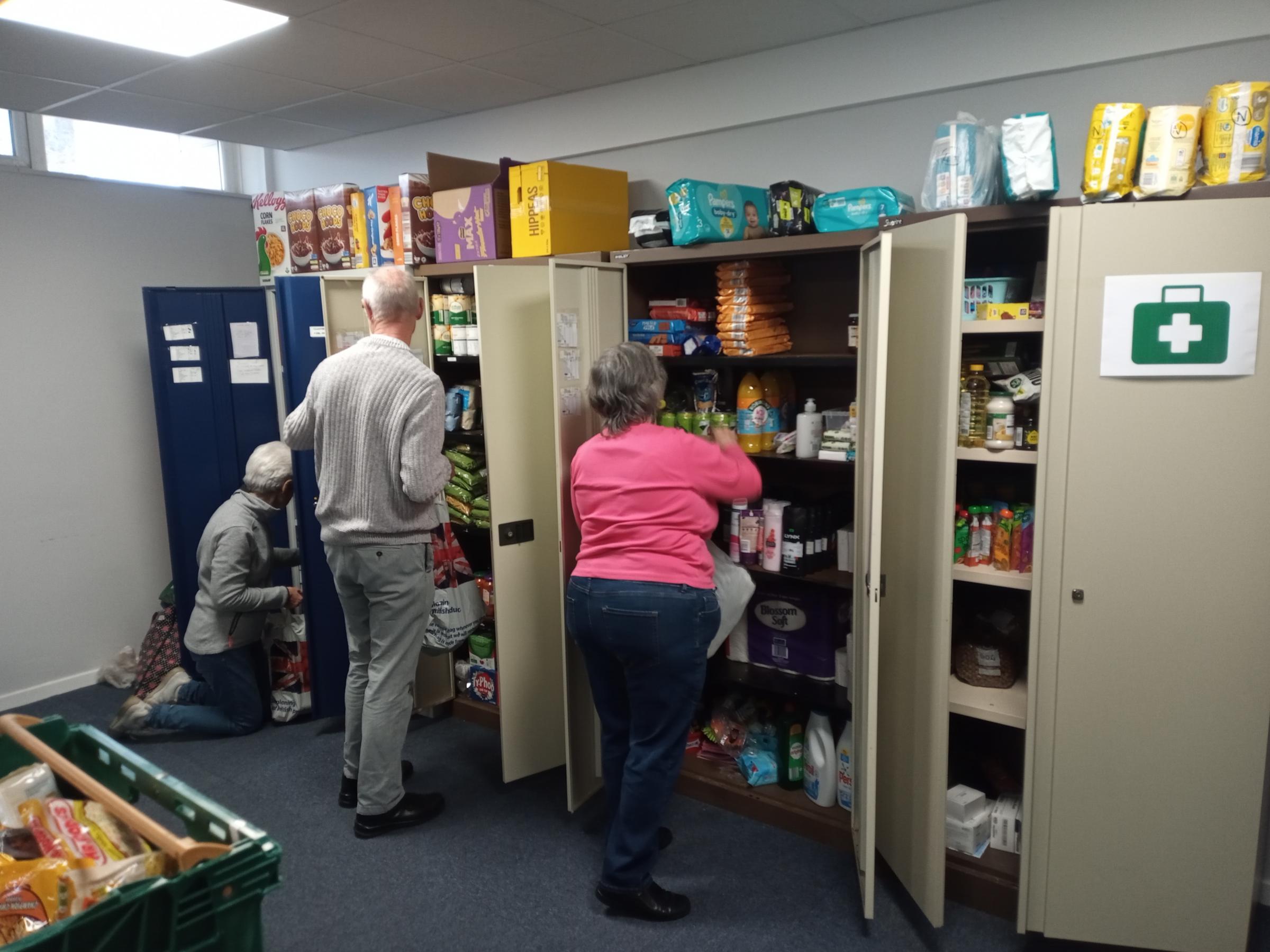 Volunteers sort items at the foodbank at St Davids Church Hall.