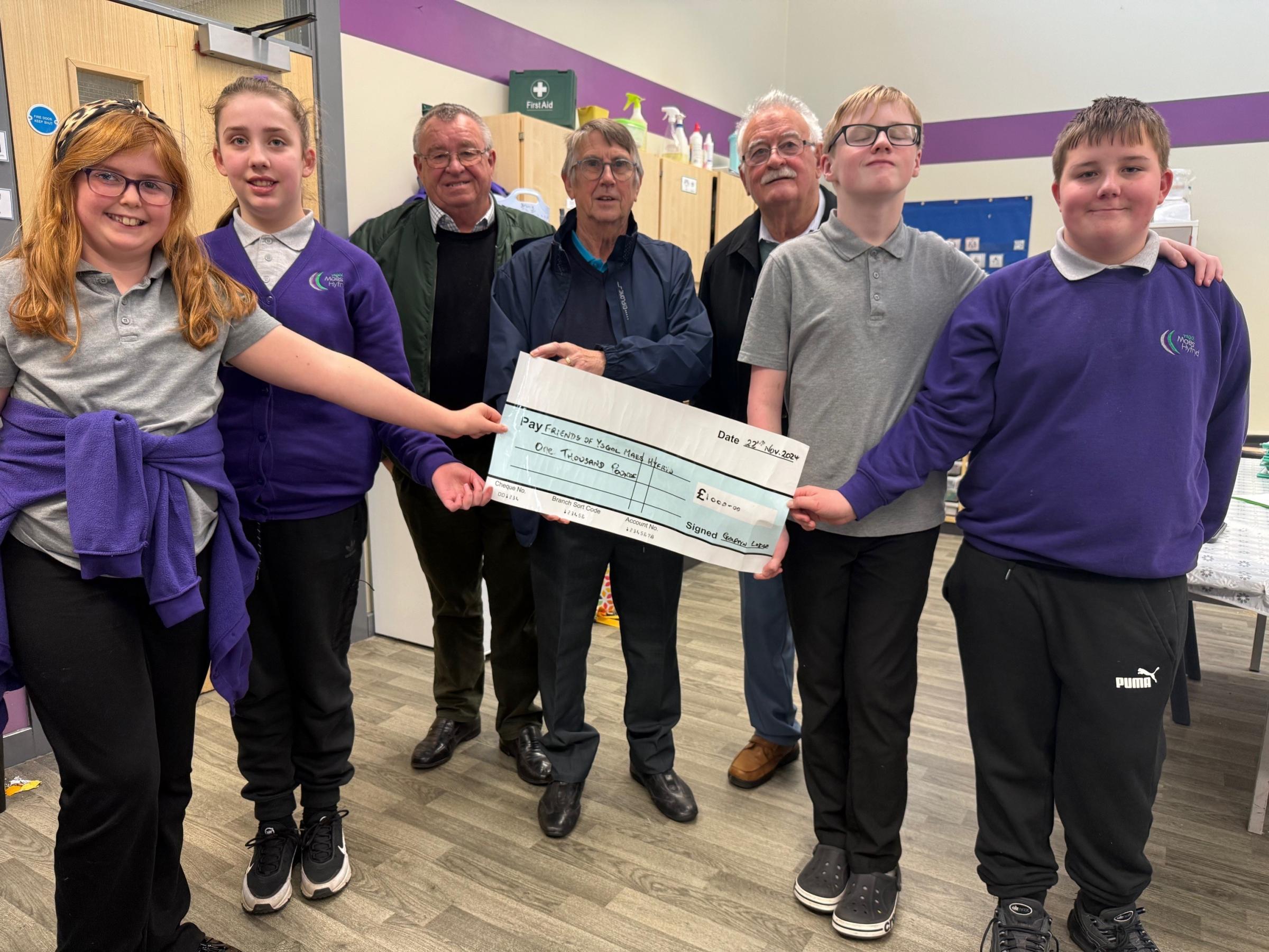 Golftyn Lodge members are John Williams (chaplain/ADC), David Jones (secretary) and Nick Griffiths (charity rep and DC), with pupils from Ysgol Maes Hyfryd.