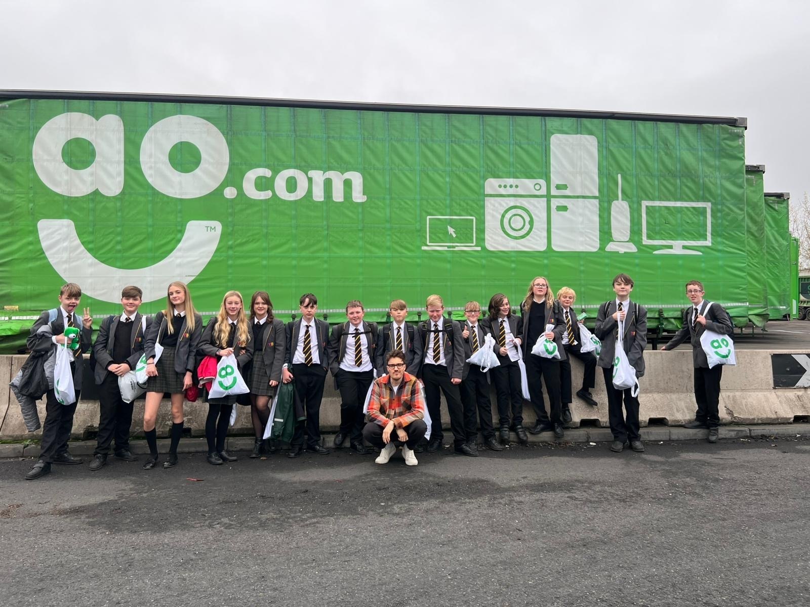 Ysgol Bryn Alyn pupils with CBBC host James Stewart, at the AO fridge recycling plant in Telford.