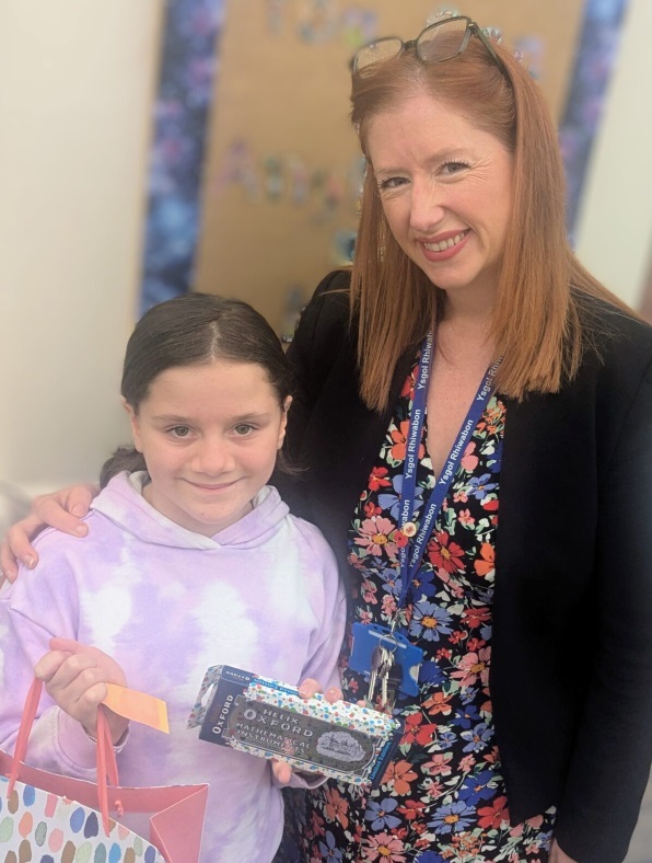 Ellie Jones, from Ysgol Acrefair, receives her prize from Ysgol Rhiwabon Curriculum Lead for Maths, Emma Beveridge.